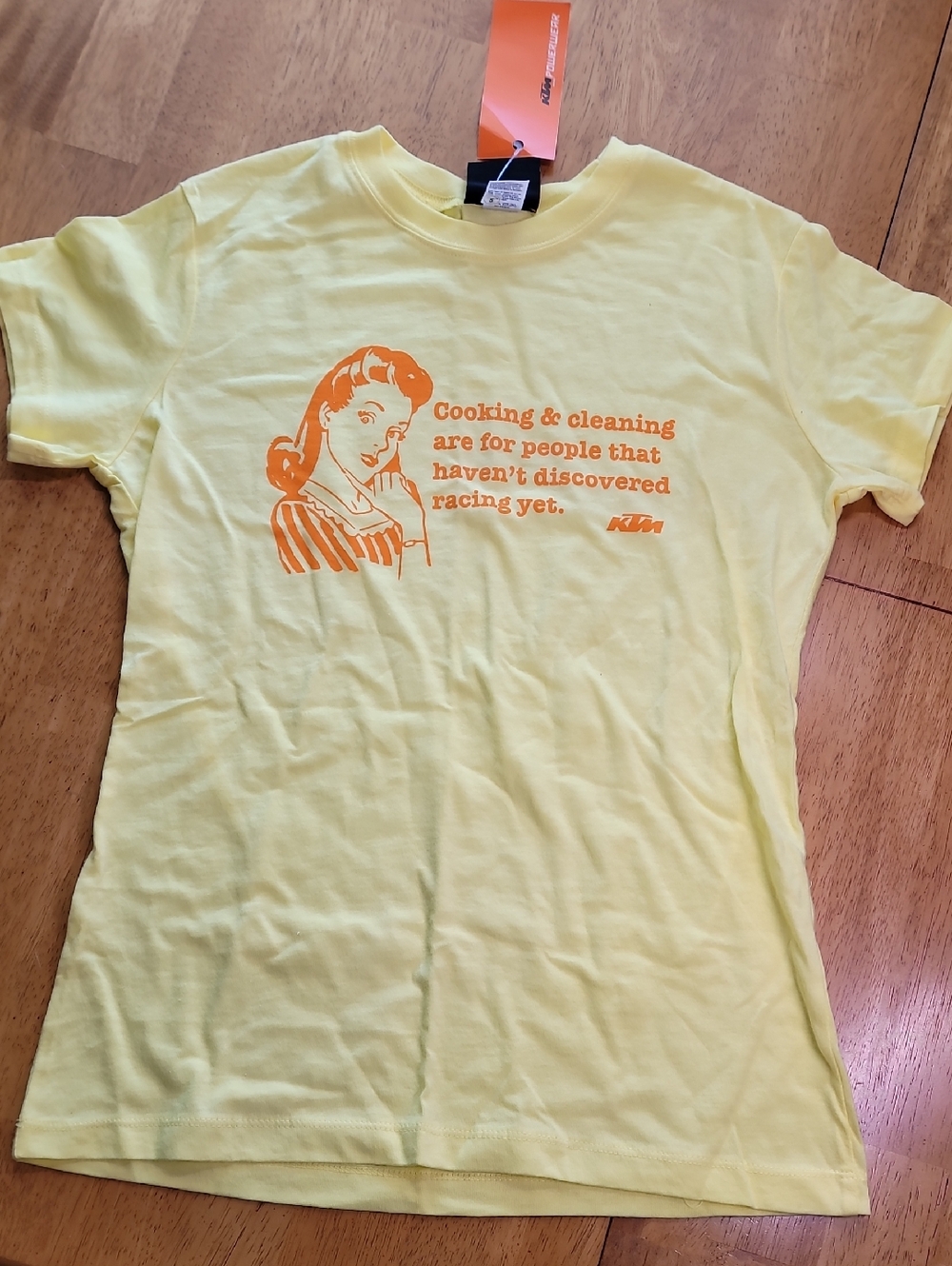 KTM Yellow retro housewife graphic and the KTM brand logo